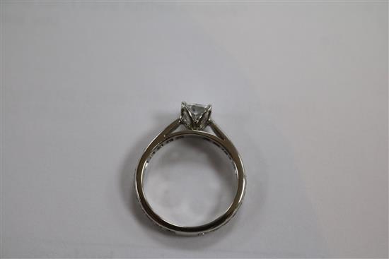 A modern platinum and single stone diamond ring with diamond set shank, size M.